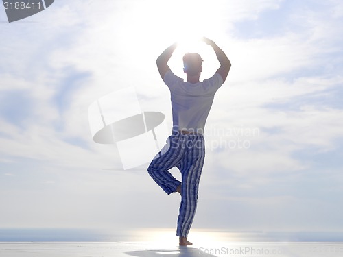 Image of young man practicing yoga