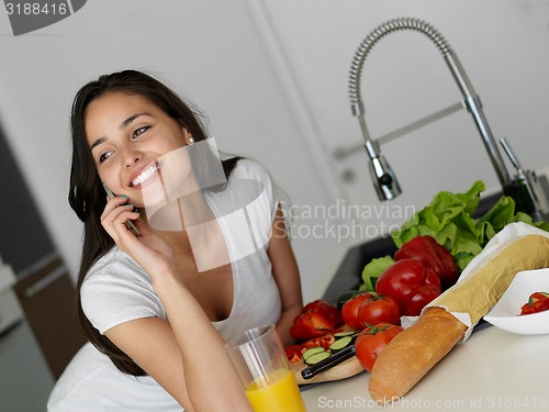 Image of Young Woman Cooking in the kitchen