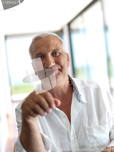 Image of Portrait of senior man relaxing in sofa