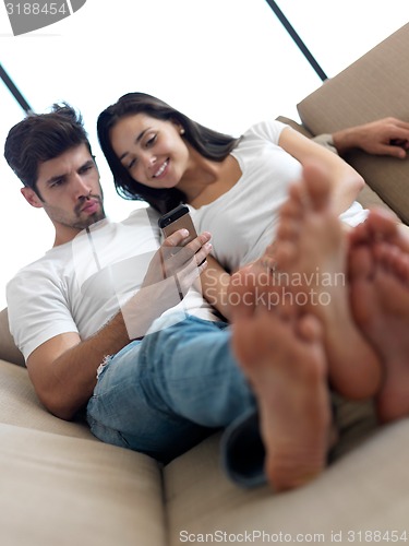 Image of young couple making selfie together at home