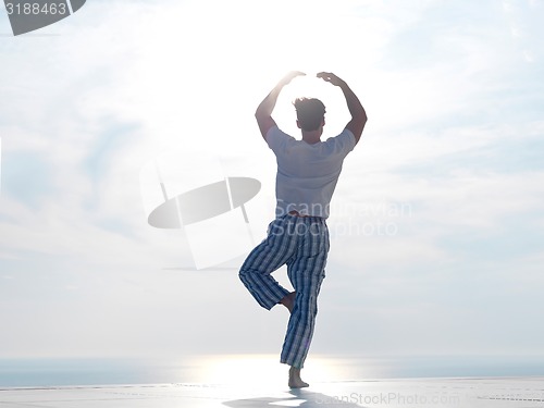 Image of young man practicing yoga