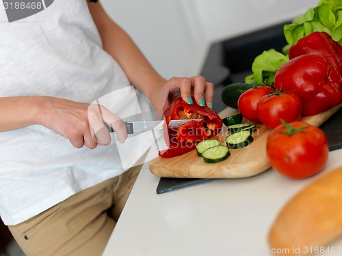 Image of Young Woman Cooking in the kitchen