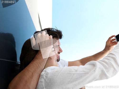 Image of young couple making selfie together at home