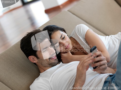 Image of young couple making selfie together at home