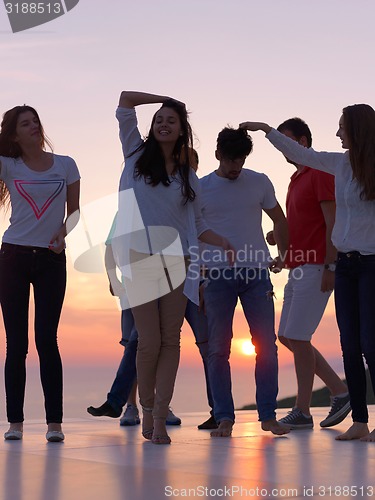 Image of party people  on sunset