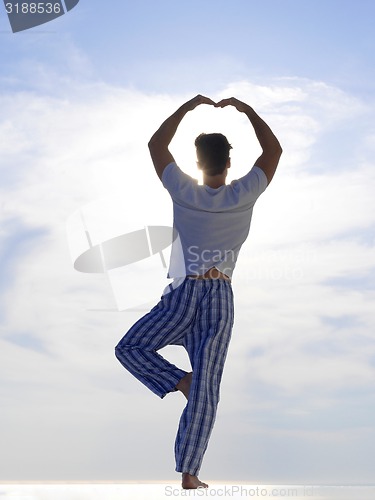 Image of young man practicing yoga