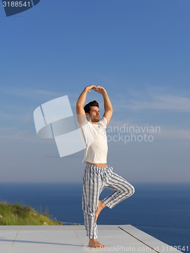 Image of young man practicing yoga