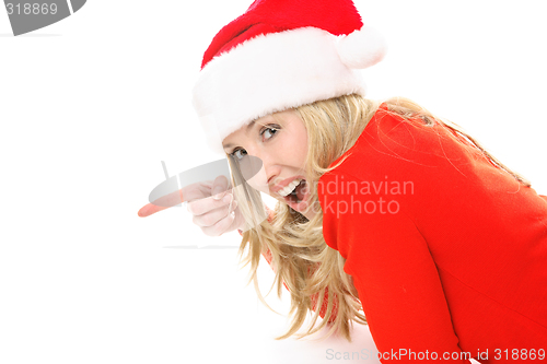 Image of Christmas girl pointing to your message or product.