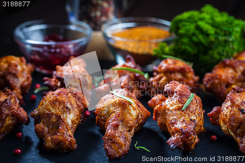 Image of BBQ chicken wings with spices and dip