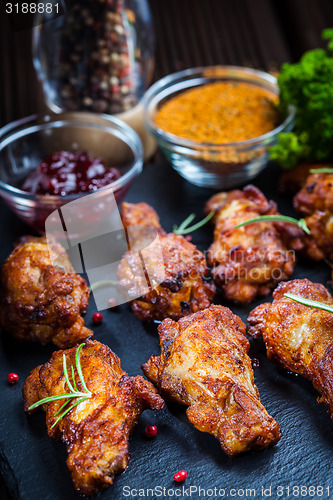 Image of BBQ chicken wings with spices and dip