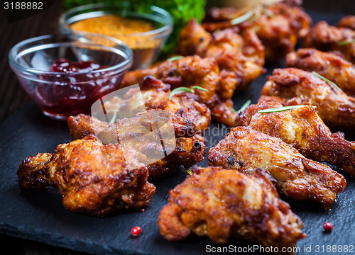 Image of BBQ chicken wings with spices and dip