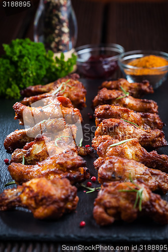 Image of BBQ chicken wings with spices and dip