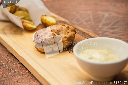 Image of Succulent cooked beef burger with potato 