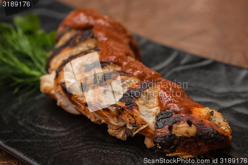 Image of the cut chicken fillet baked in spices and tomato sauce