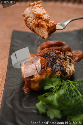 Image of the cut chicken fillet baked in spices and tomato sauce
