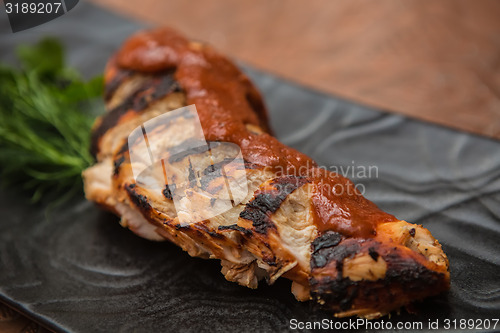 Image of the cut chicken fillet baked in spices and tomato sauce