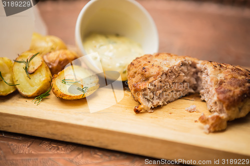 Image of Succulent cooked beef burger with potato 