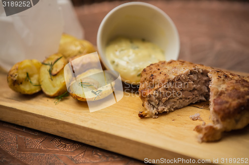 Image of Succulent cooked beef burger with potato 