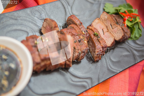 Image of organic fresh ripe roasted beef meat with sauce