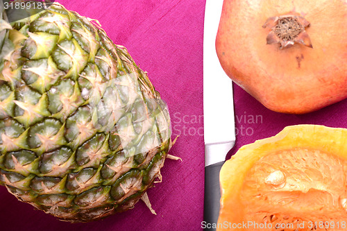 Image of fresh pineapple with pumpkin and knife