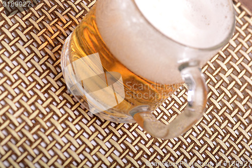 Image of Glass of fresh beer with cap of foam