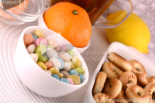 Image of candies and fruits, tea (coffee) cup and fruits