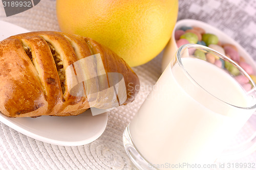 Image of sweet cake on white plate and fruits with milk
