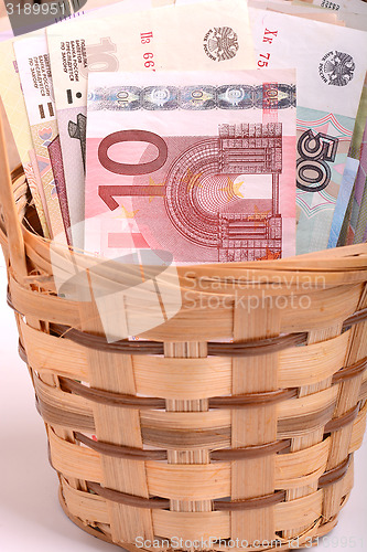 Image of money set in a basket, dollars, euro and ukrainian money