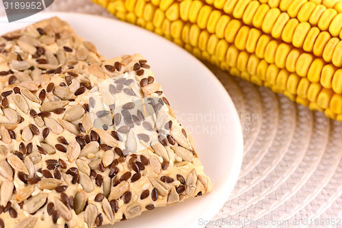 Image of sweet cake on white plate and corn