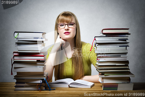 Image of Famale Student with many books