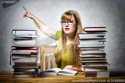 Image of Female teacher pointing back