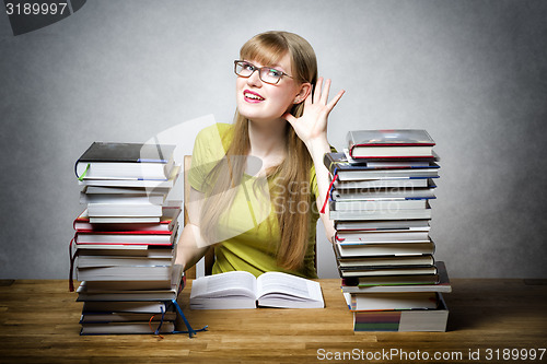 Image of Listening female student with books