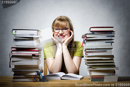 Image of happy female student with books