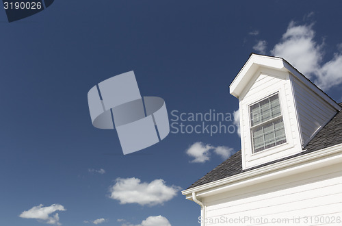 Image of Roof of House and Windows Against Deep Blue Sky