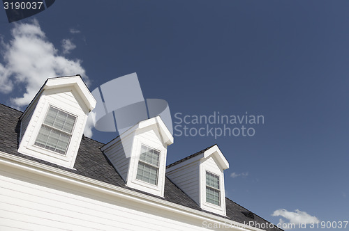 Image of Roof of House and Windows Against Deep Blue Sky