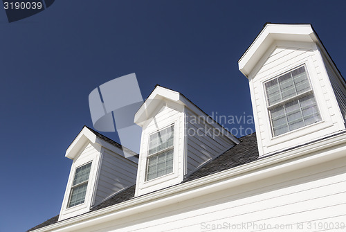 Image of Roof of House and Windows Against Deep Blue Sky