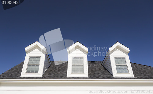 Image of Roof of House and Windows Against Deep Blue Sky