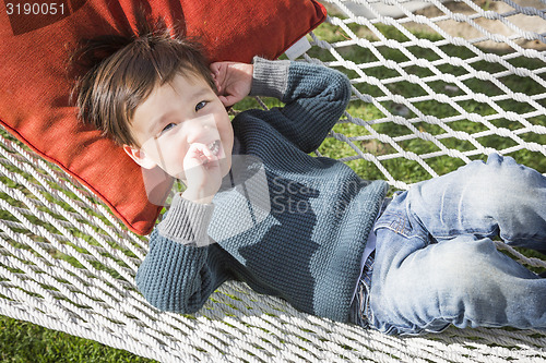 Image of Cute Mixed Race Boy Relaxing in Hammock