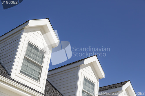 Image of Roof of House and Windows Against Deep Blue Sky