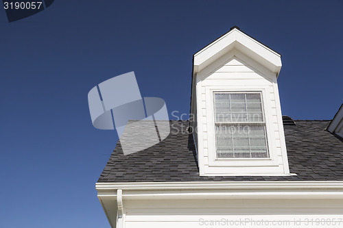 Image of Roof of House and Windows Against Deep Blue Sky