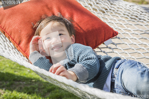 Image of Cute Mixed Race Boy Relaxing in Hammock