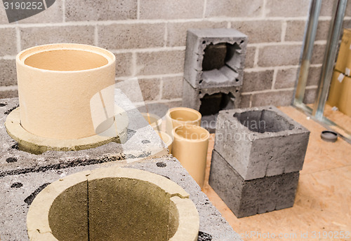 Image of Construction of modular ceramic chimney in the house