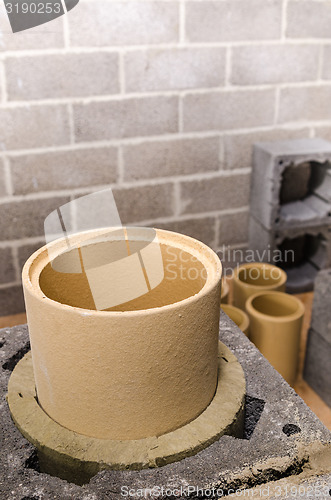 Image of Construction of modular ceramic chimney in the house