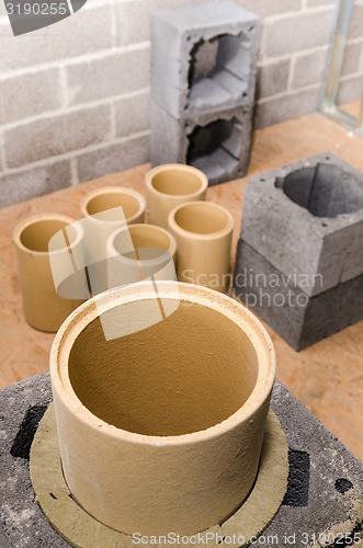 Image of Construction of modular ceramic chimney in the house