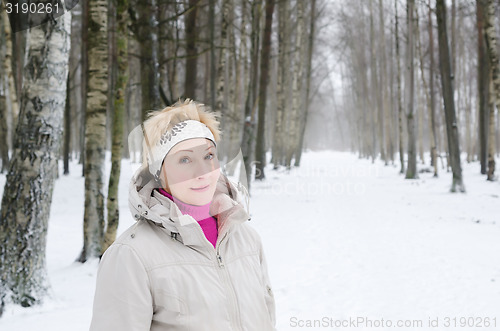 Image of Portrait of a middle-aged woman on the background of a winter al