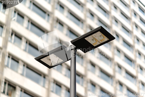 Image of Modern streetlamp and concrete building