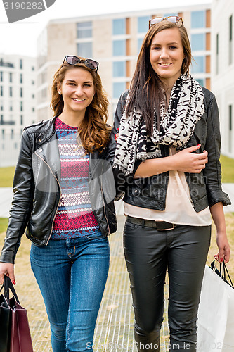 Image of Two attractive girls shopping