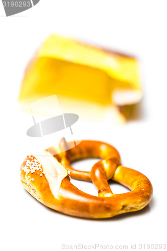 Image of Fresh German pretzel  out of its paper bag on white 