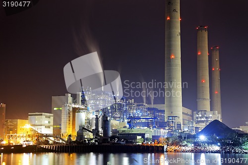 Image of power station at night with smoke