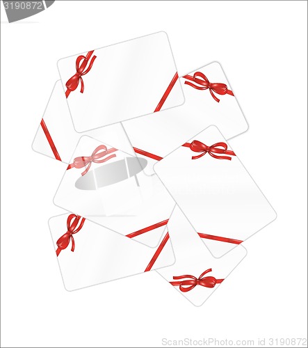 Image of mess of white gift cards with red ribbon and bow